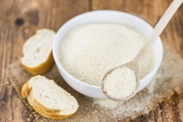 Breadcrumbs on a wooden spoon (close-up shot; selective focus)
