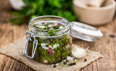 Chimichurri on an old wooden table (selective focus)