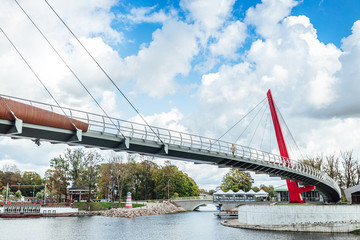 Modern pedestrian bridge over river in city of Jelgava.