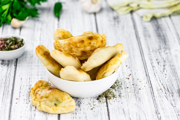 Some fresh made Empanadas (selective focus; close-up shot)