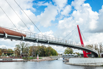Obraz premium Modern pedestrian bridge over river in city of Jelgava.