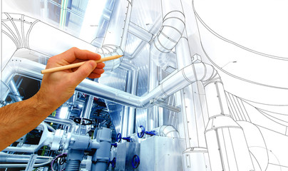 man's hand draws a design of factory combined with photo of modern industrial power plant