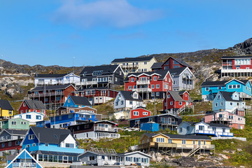 Fototapeta na wymiar Colored houses on rocky hills in Qaqortoq, Greenland.