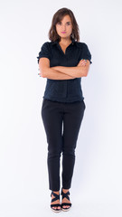 Full body shot of beautiful businesswoman with arms crossed