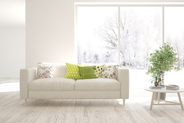 Stylish room in white color with sofa and winter landscape in window. Scandinavian interior design. 3D illustration