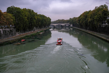 Rome, river tiber view with tourists on traditional boat, italy © paolo