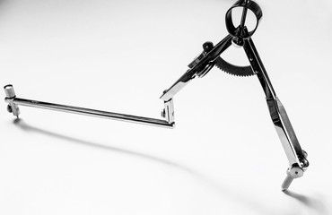 Stainless steel compass for freehand drawing of circles on paper.