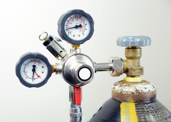 Closeup of manometer, measuring gas pressure. Pipes and valves at industrial plant. 