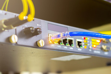 blue cable network cables connected to switch port concept business connection information internet, flare light