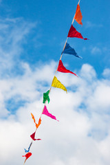 multi-colored flags against a blue sky