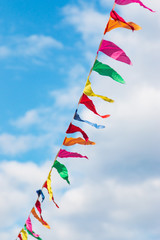 multi-colored flags against a blue sky