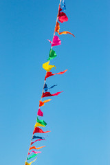 multi-colored flags against a blue sky