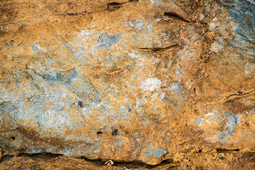 The texture of the stone overgrown with moss. Background image of a boulder