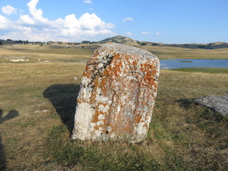 old stone monuments with representations of arches