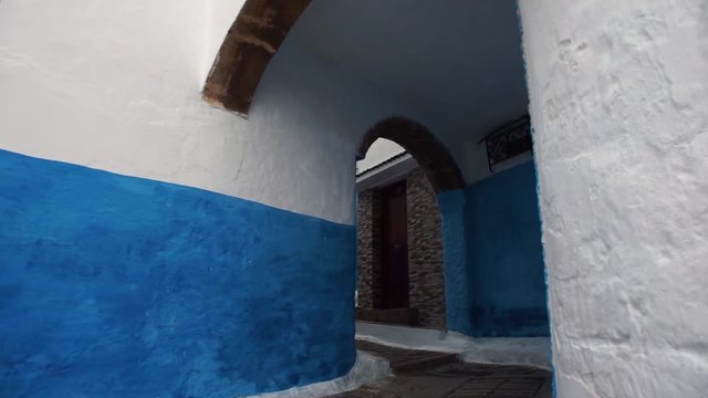 walking in a lane inder an ancient building in the Kasbah of oudayas, Rabat, Morocco