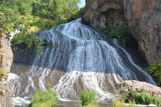 Beautiful waterfall. A tall waterfall descends through the rocks. Jermuk waterfall is located in Jermuk, Armenia