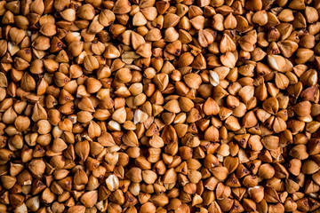 The texture of dry buckwheat. Background image of buckwheat porridge. Maro's Photo