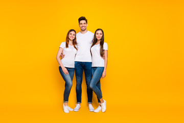 Full size photo of handsome people standing wearing white t-shirt denim jeans isolated over yellow background