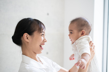Female nurse holding a baby in hospital