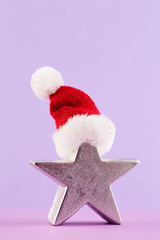 Christmas star, decor on pastel colored background. Christmas or New Year minimal concept.