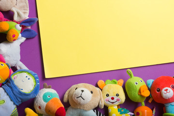 Obraz premium Colorful kids toys frame on wooden background. Top view. Flat lay. Copy space for text.