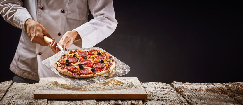 Chef making a homemade pepperoni pizza
