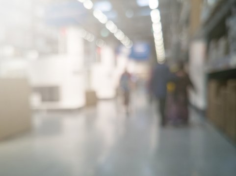 defocused images of environment and people shopping inside a hypermarket with added flares