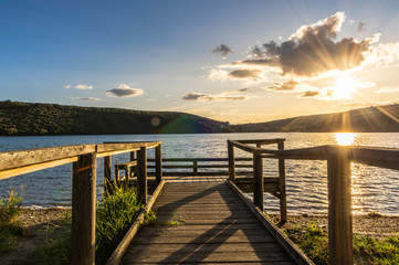 Obraz premium Views during the beautiful sunset on the dock for fishing of the Selga de Ordas reservoir in Leon, Spain