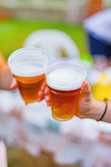 Friends enjoying drinking beer in the backyard.