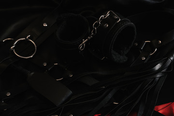 Handcuffs and a whip Concept of sex toys for BDSM with submission and domination