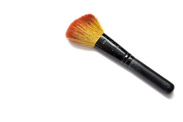 cosmetic brush for applying powder on a white background