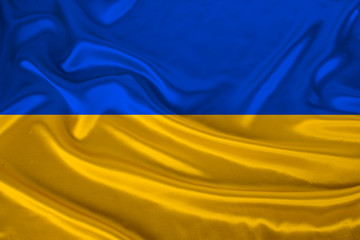 national flag of Ukraine on gentle silk with wind folds, travel concept, immigration, politics, close-up, copy space, illustration