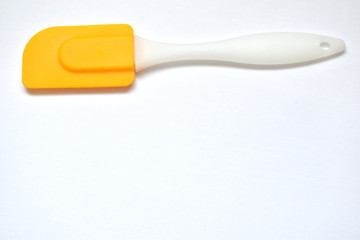 yellow culinary spatula on a white background