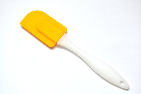 yellow culinary spatula on a white background - Powered by Adobe
