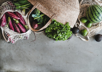 Eco-friendly lifestyle. Flat-lay of of grocery jute and net bags with fresh organic vegetables,...
