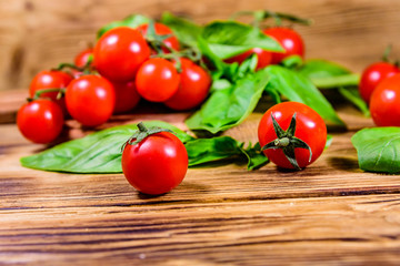 Heap of small cherry tomatoes on wooden table