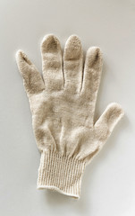 one work new cotton glove on a white background lies with spread out fingers