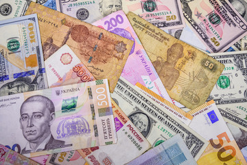 Multi currency background. Euro, american dollars, ukrainian hryvnias, egyptian pounds, russian roubles