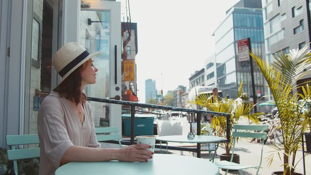 Attractive girl in a summer cafe in New York