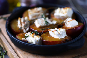 Baked plums with feta cheese. Healthy lunch or snack. Vegetarian food. Selective focus. Macro.