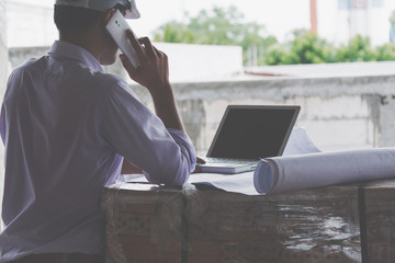 Consultant engineer discussing construction project in blueprint; Consulting concept in construction at office indoor