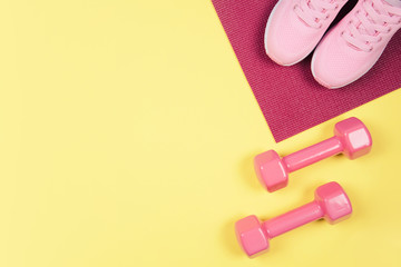 Flat lay shot of sneakers on yellow background.