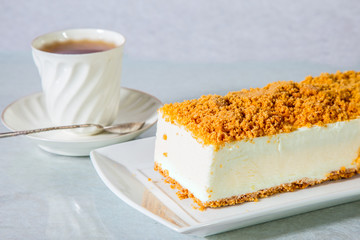 Cheesecake and cup with tea