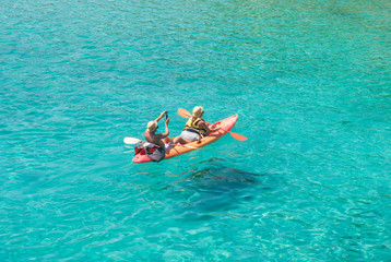 Couple of adult on a kayak in a clear sea