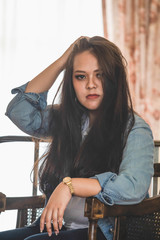 Portrait of young Asian woman wearing jeans jacket.