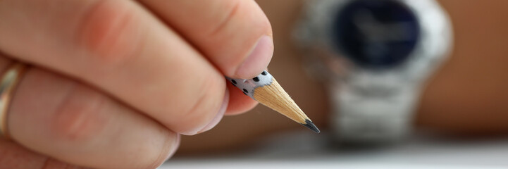 Male hand holding simple pencil ready to draw