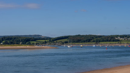 Sunny day view of the river Exe estuary at Exmouth, with assorted unidentifiable boats moored. Devon, England.