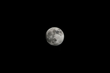 Full moon against starry night sky