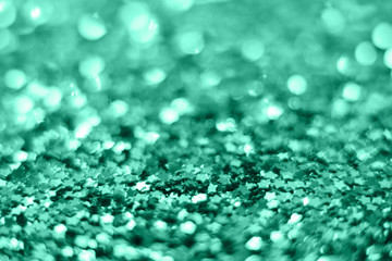 Mint Christmas background from sparkles of stars. blurred