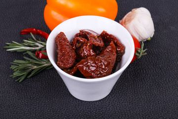 Dried tomatoes in the bowl with olive oil
